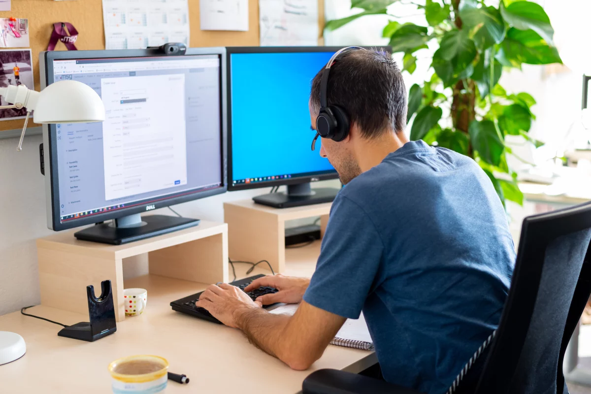 Scrum master Michal typing in his work computer